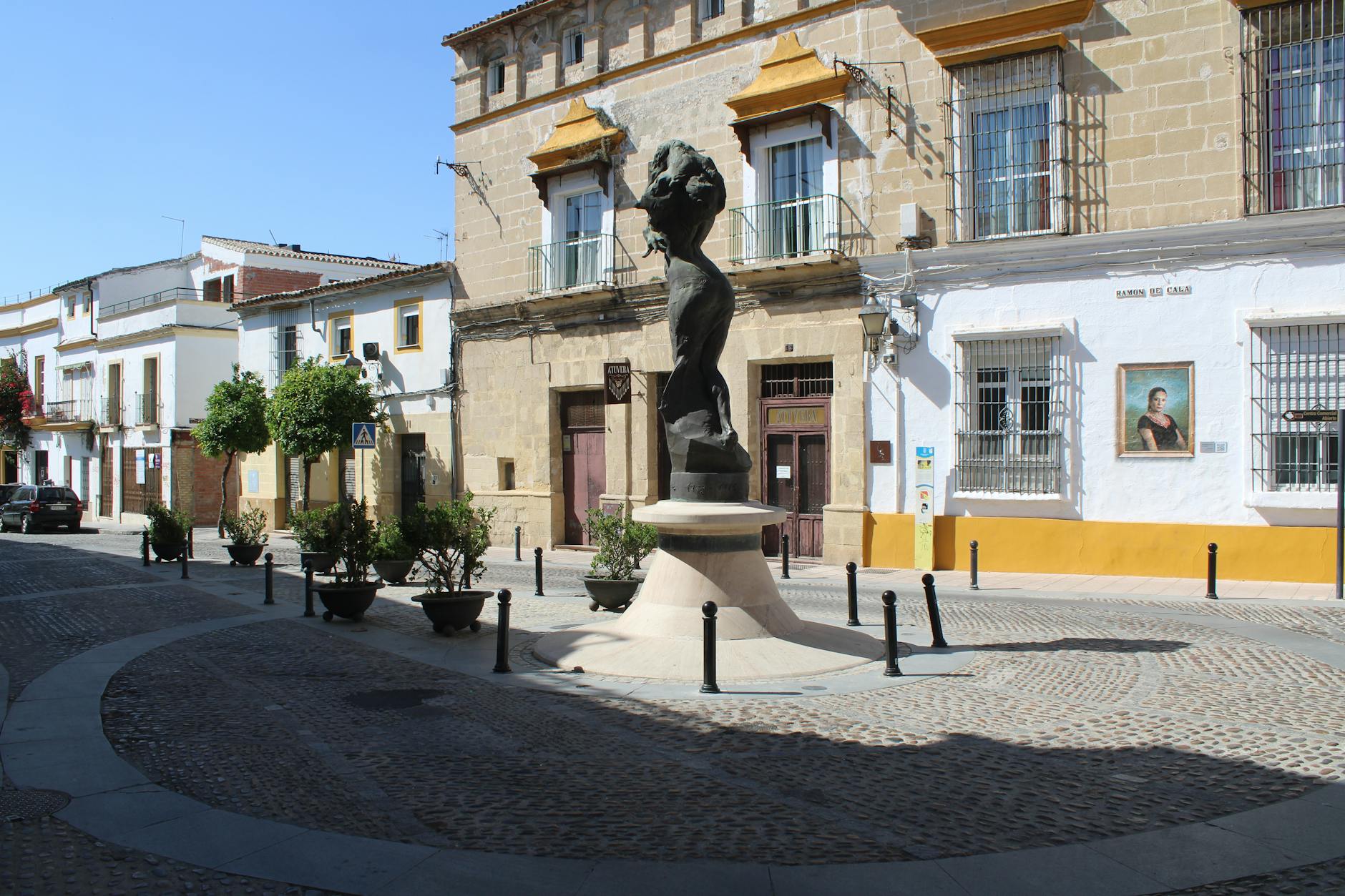 Discover the Lola Flores monument in a sunlit square in Jerez de la Frontera, showcasing urban Spanish culture.