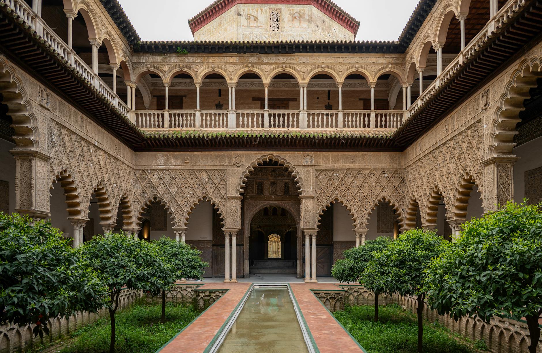 Stunning view of the Moorish architecture at the Alcázar of Seville's Patio de las Doncellas.