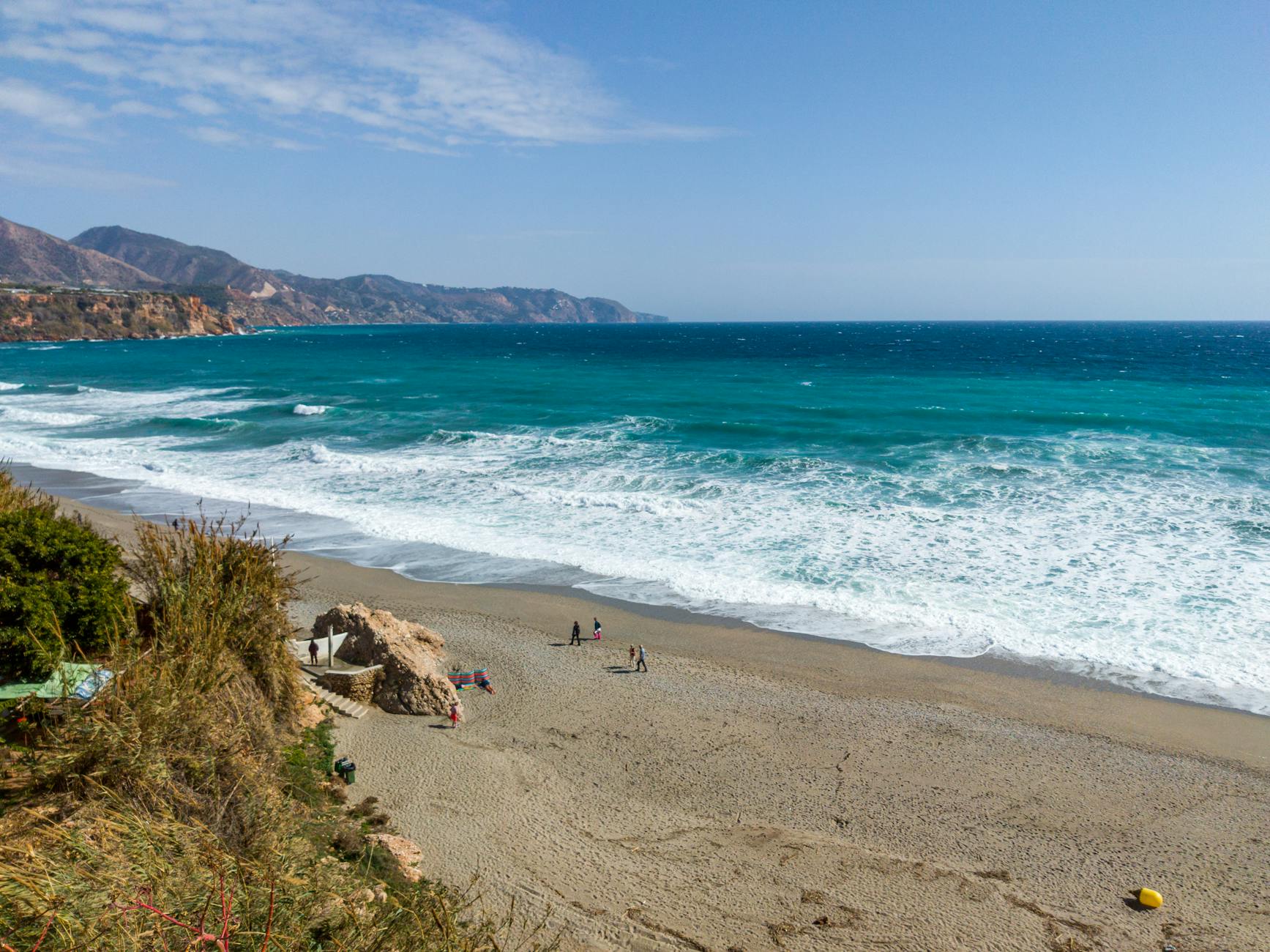 Stunning aerial view of Nerja Beach, Spain, featuring turquoise waters and scenic coastline.