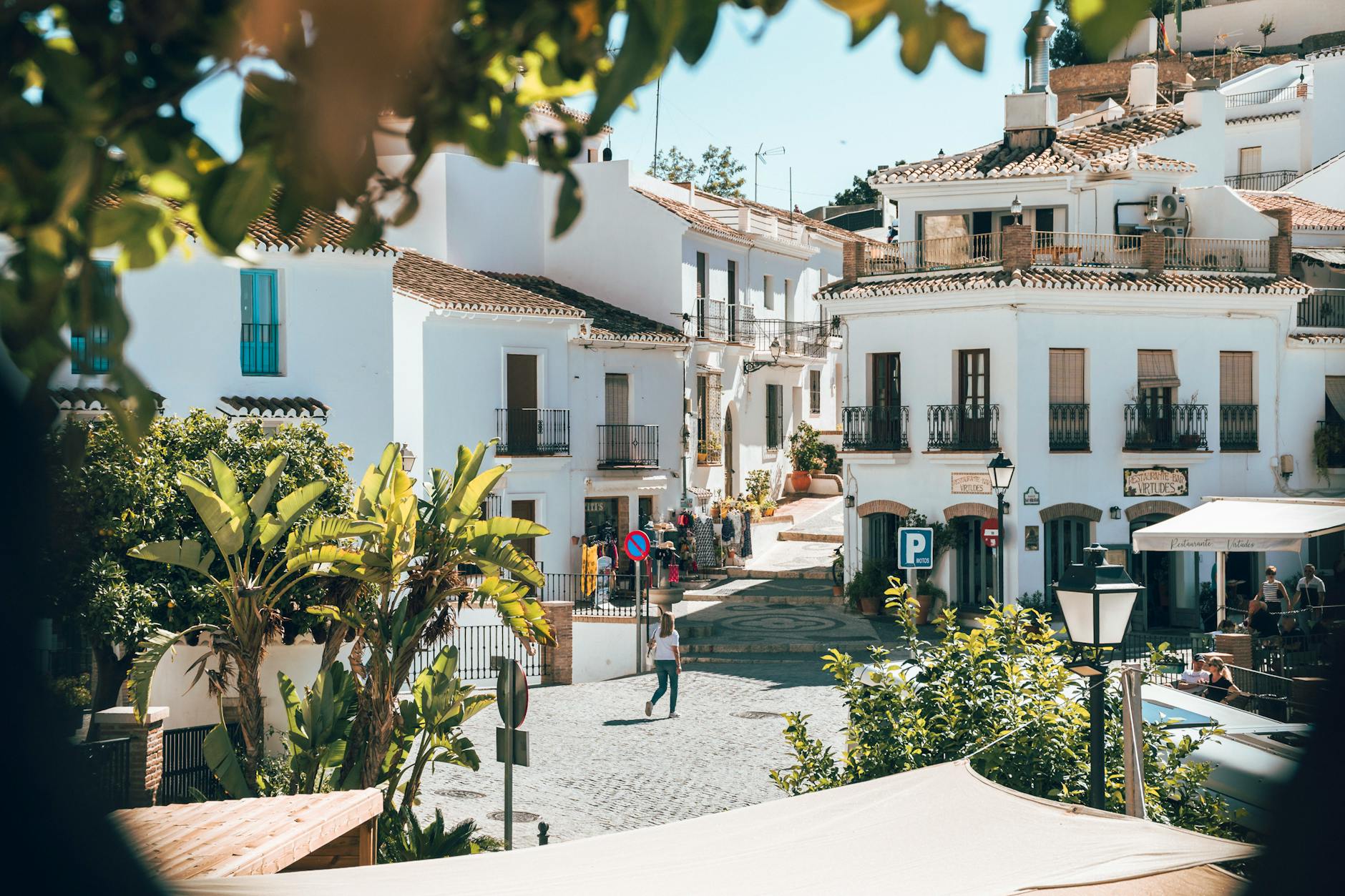 Sunny day in Frigiliana, Spain with its iconic whitewashed architecture and vibrant greenery.