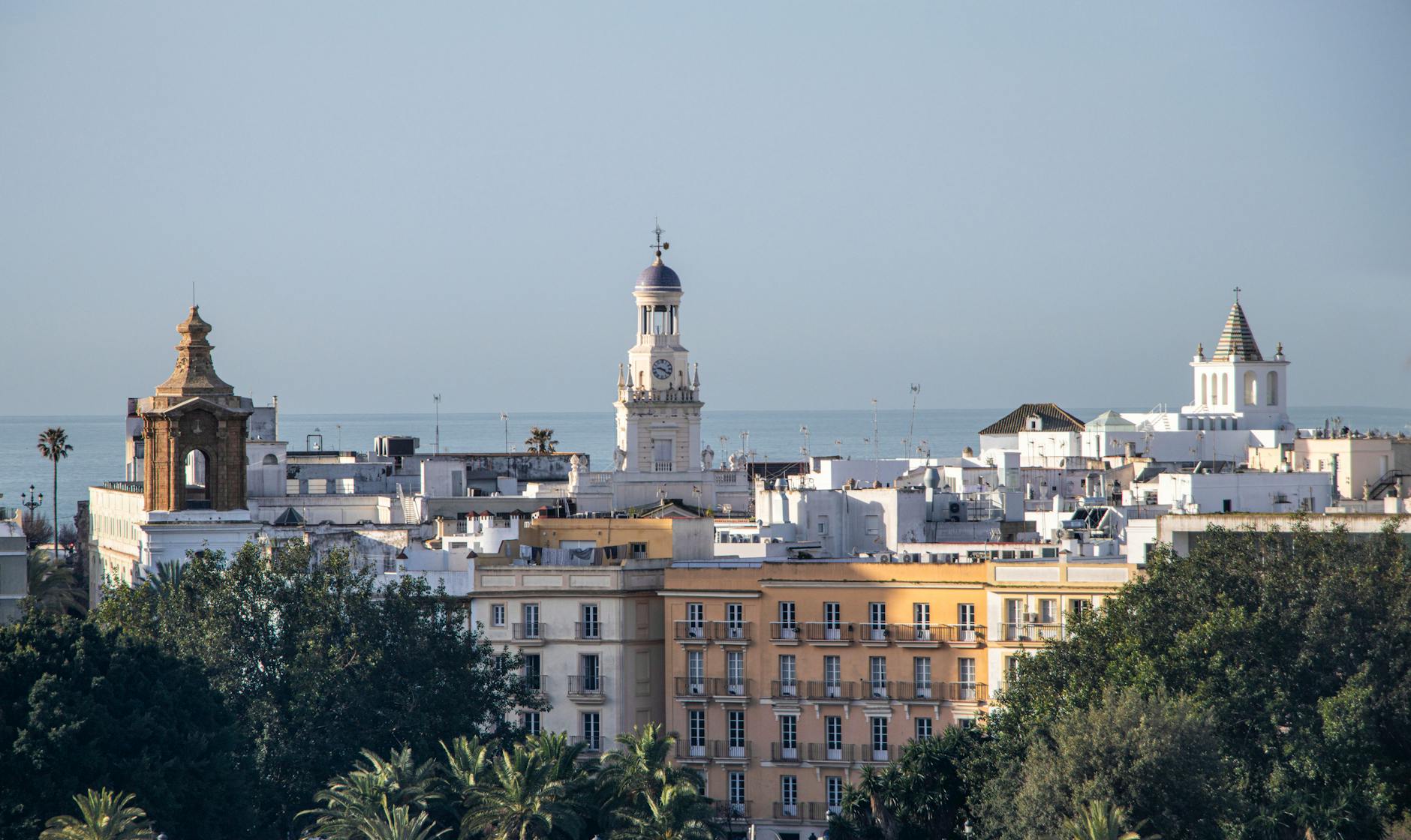 A picturesque view of Cádiz with historic architecture and blue sky.