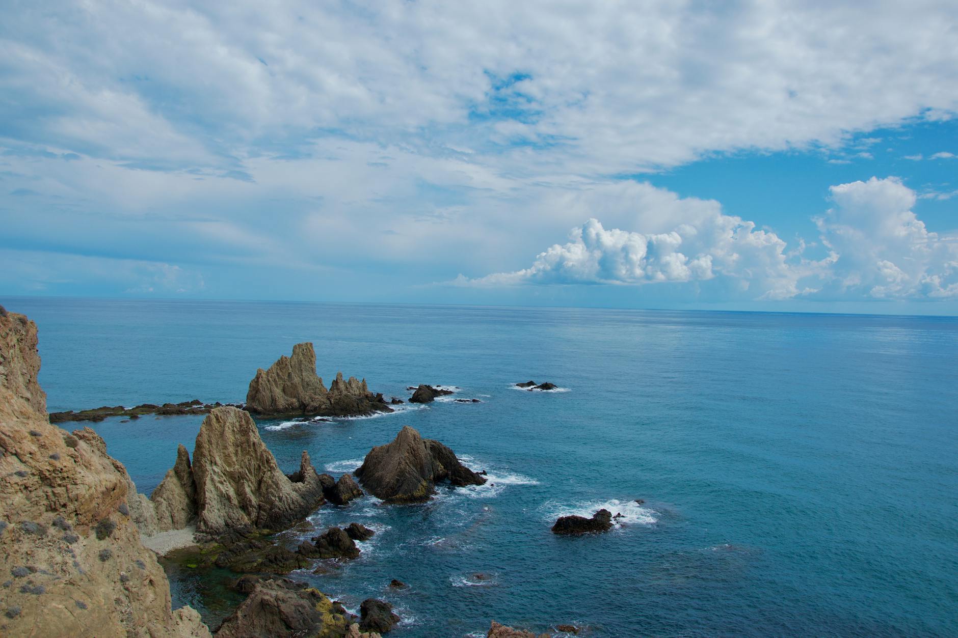 Breathtaking view of rocky seascape at Cabo de Gata in Spain with azure blue sea and sky.