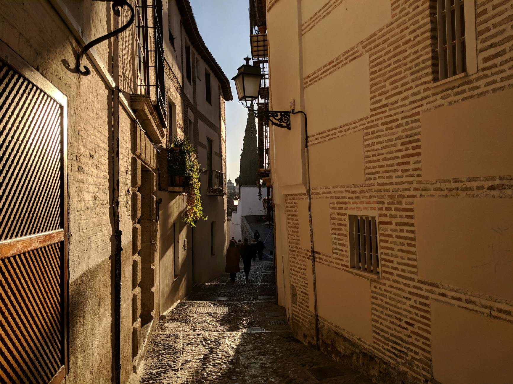 Explore the charming cobblestone streets of Granada, Spain at dusk, capturing timeless beauty.