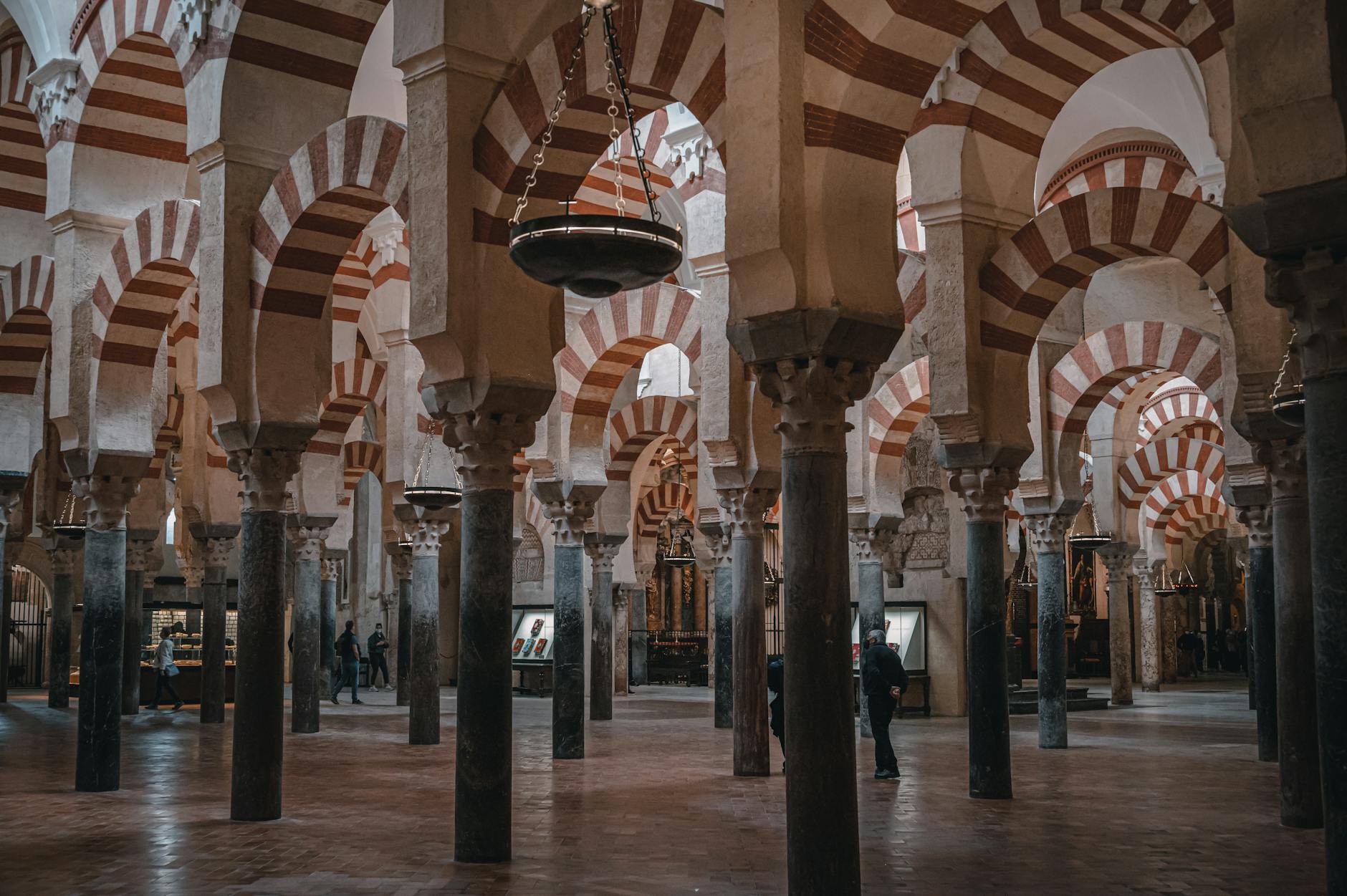 Explore the historic Mosque-Cathedral of Córdoba's stunning arches and columns in this captivating interior view.