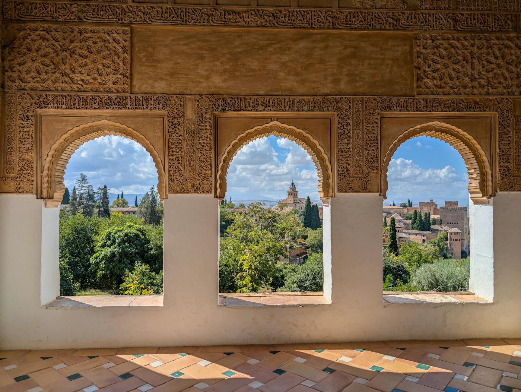 Explore the Alhambra's stunning arches overlooking historic Granada, Spain.