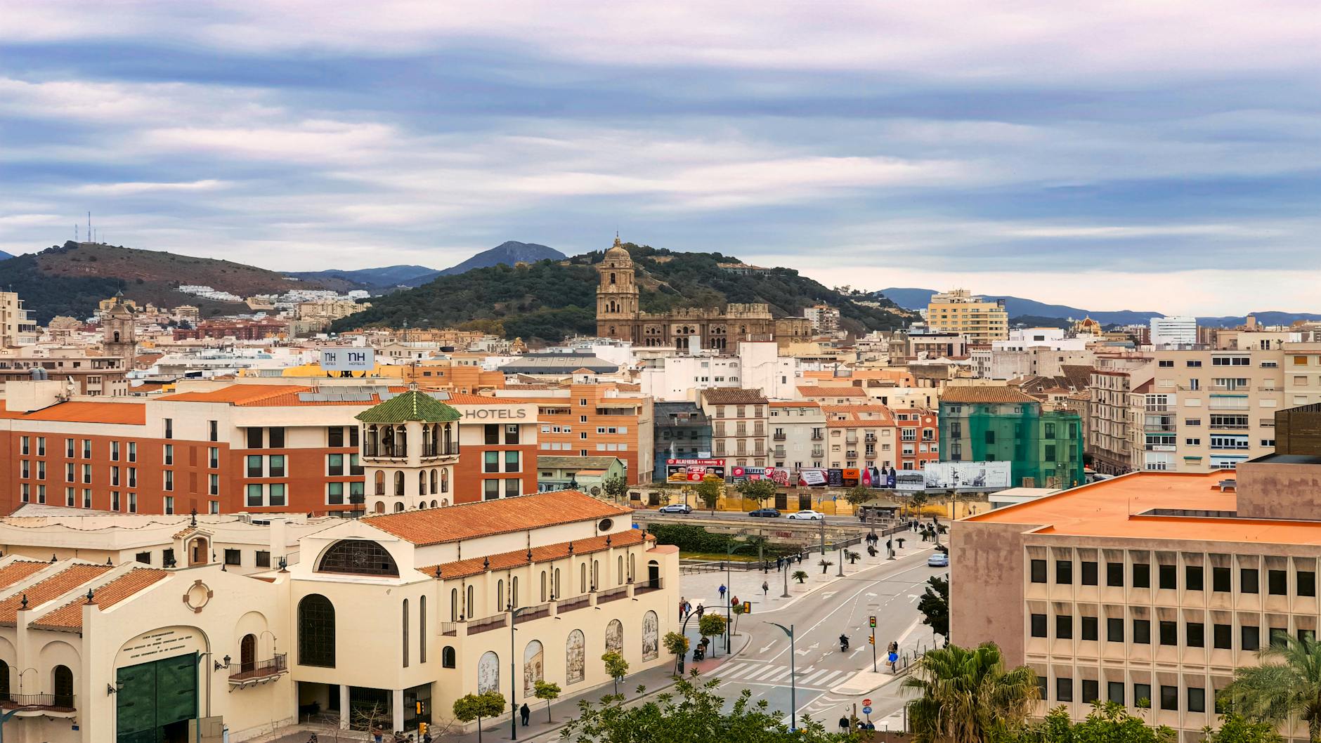 Explore the vibrant cityscape of Málaga featuring historic architecture and modern buildings.
