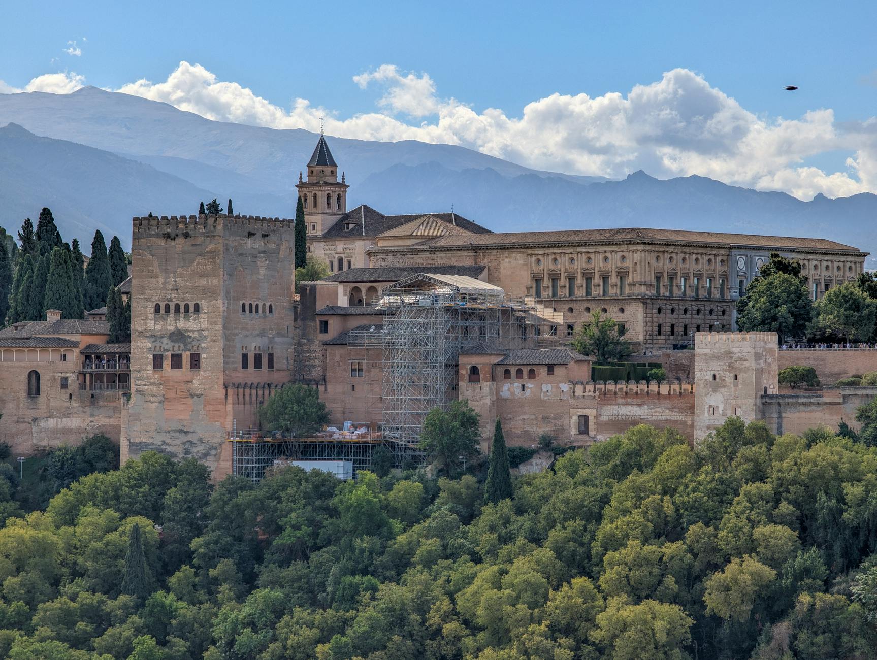 Stunning view of the Alhambra palace set against the Sierra Nevada mountains in Granada, Spain.