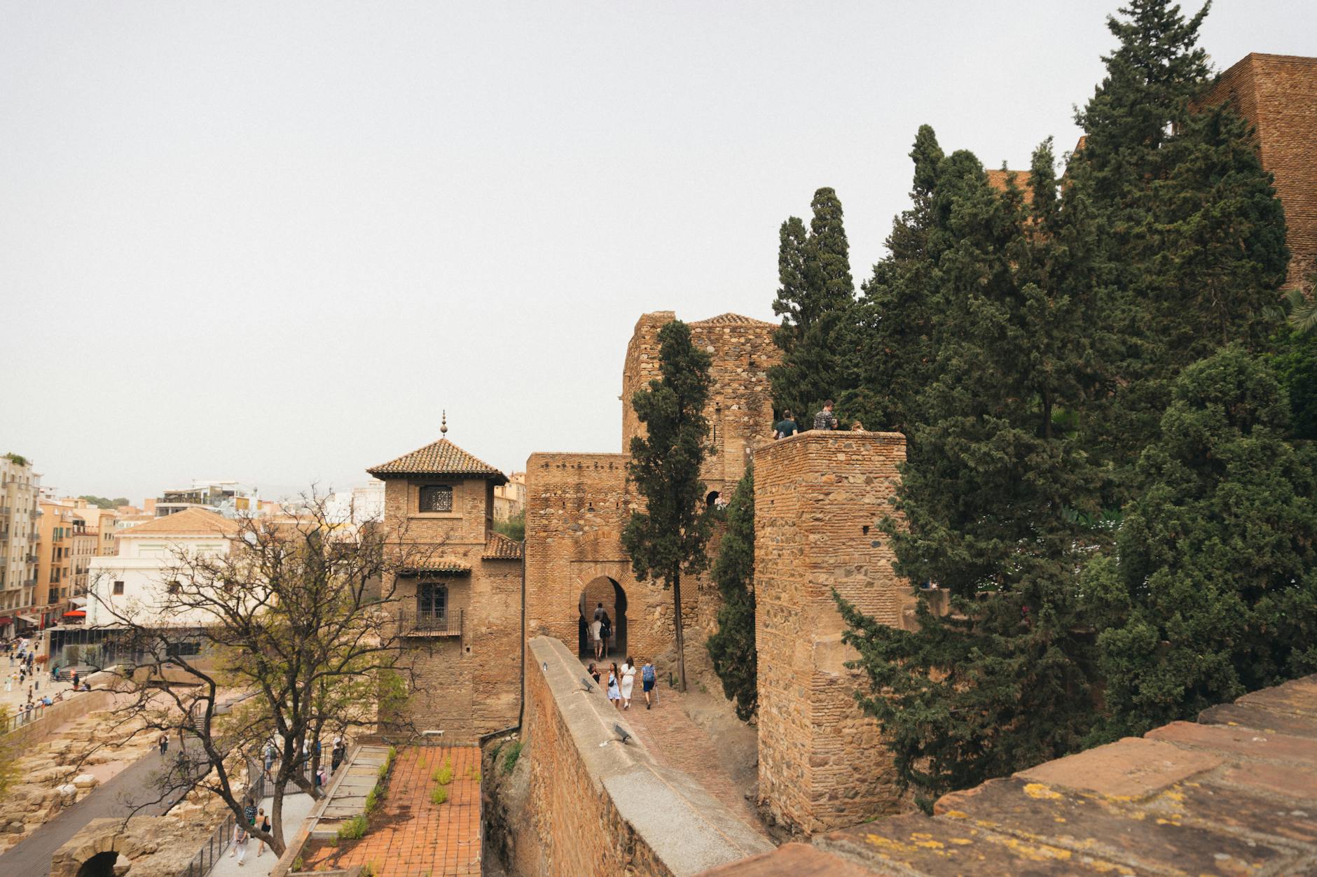 View of the Alcazaba in Málaga, showcasing ancient fortress architecture amidst lush greenery.