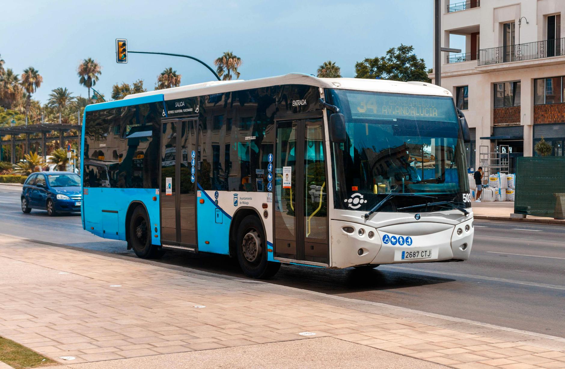 Public bus on a sunny day in Málaga, showcasing urban transportation.