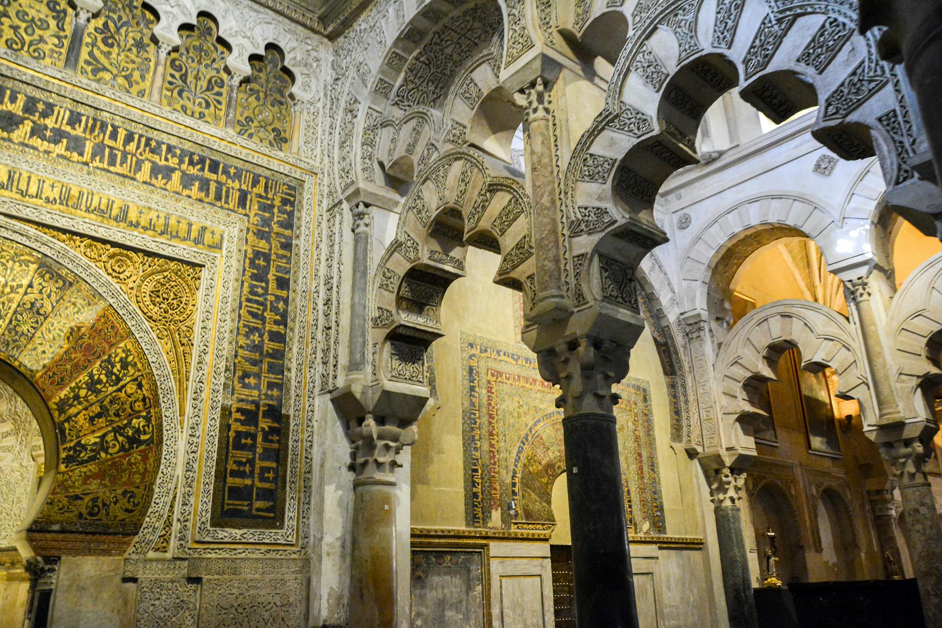 Stunning Moorish architecture featuring intricate arches and carvings within the Mosque-Cathedral of Córdoba.