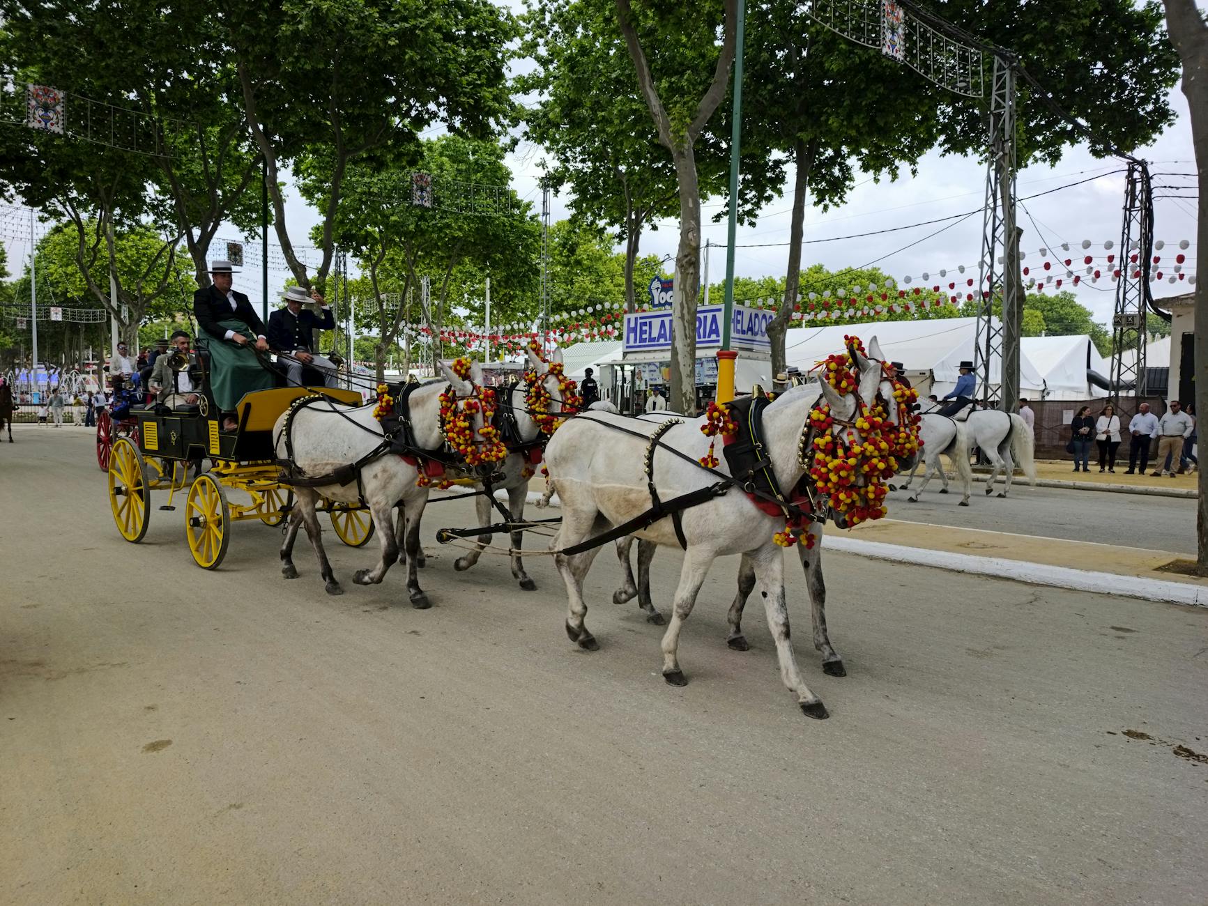 A decorated horse-drawn carriage at a vibrant Andalusian fair in El Puerto de Santa María.