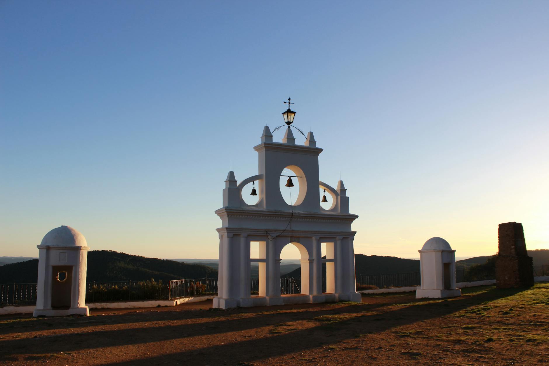 Beautiful view of a bell gate landmark in Sierra de Aracena, Spain, captured at sunset.